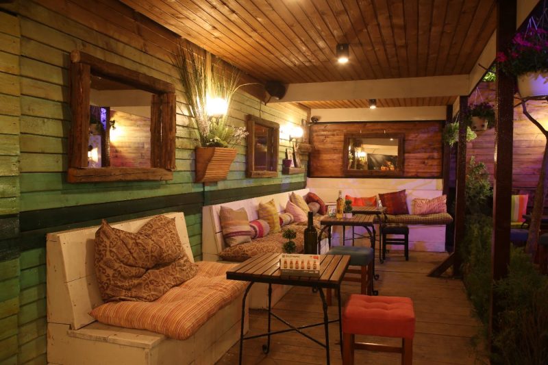 Covered Wooden Terrace Lounge with Warm Lights
