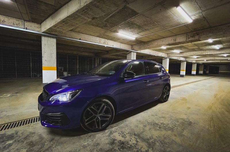 Blue Car in an Underground Parking Garage