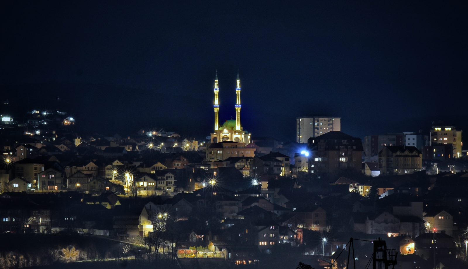 City Lights and a Lit Mosque at Night