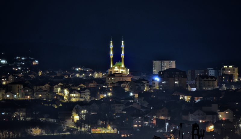 City Lights and a Lit Mosque at Night