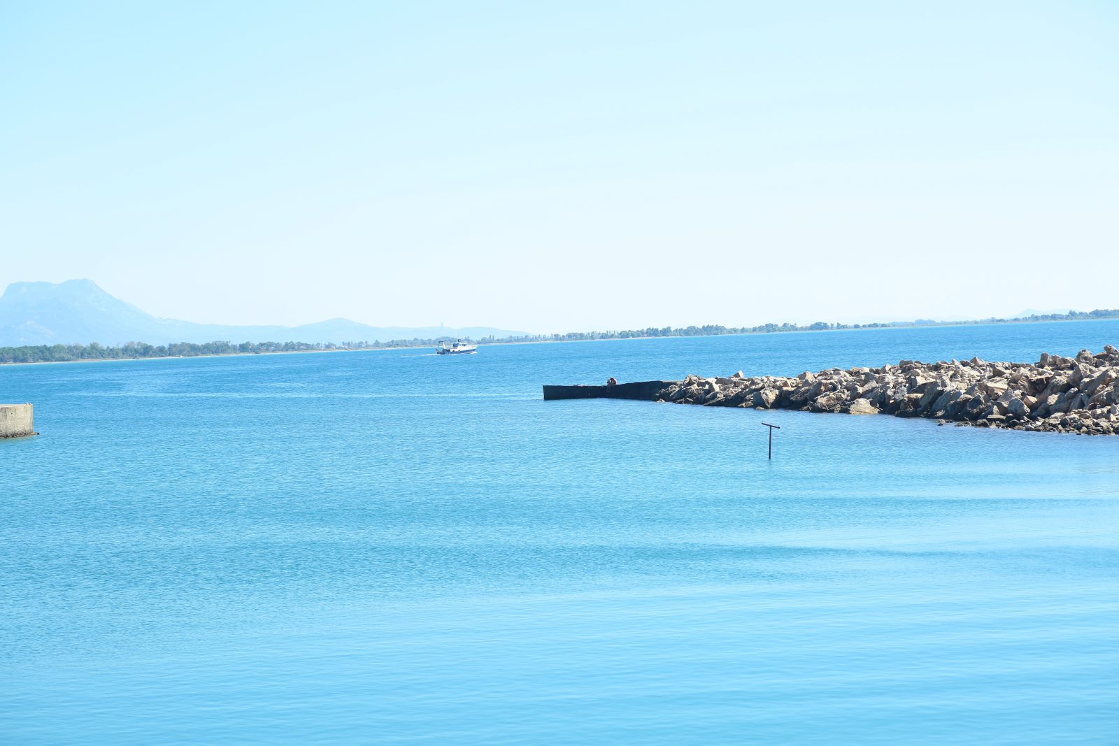 Calm Blue Sea and a Stone Breakwater