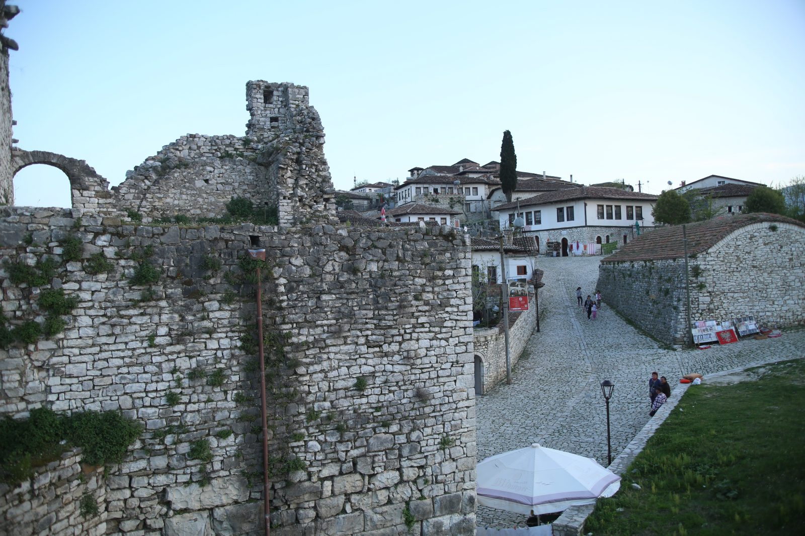 Castle Walls Beside a Cobblestone Street