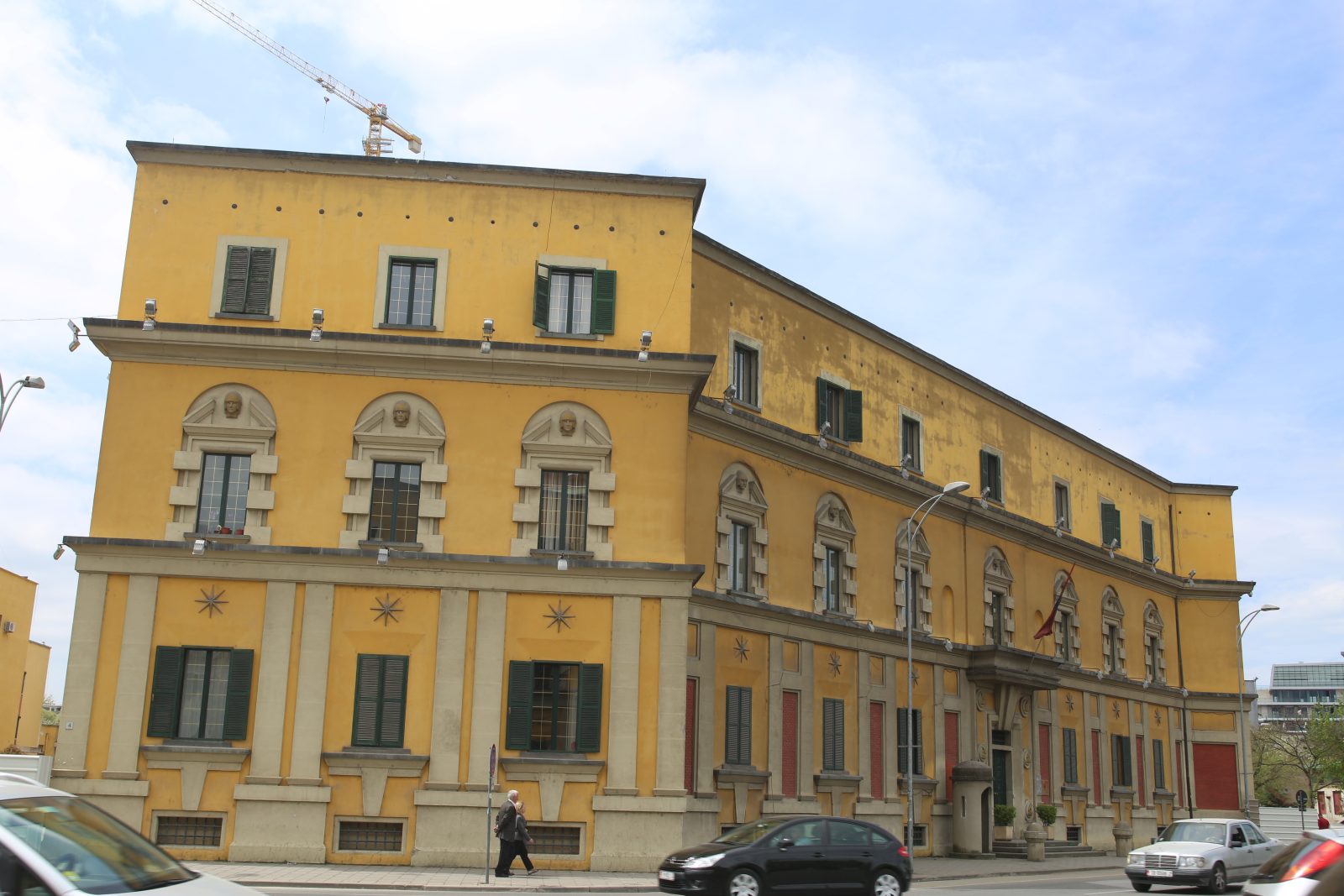 Yellow Neoclassical Building on a City Street