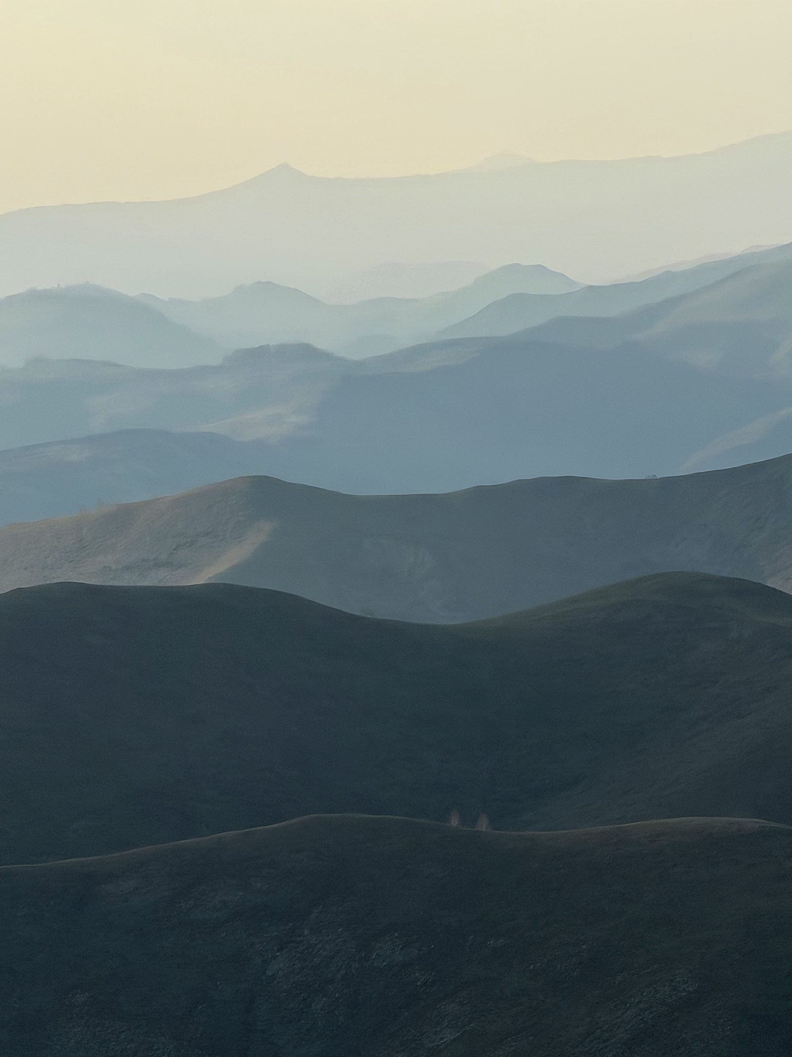 Layered Blue Mountain Ridges in Haze