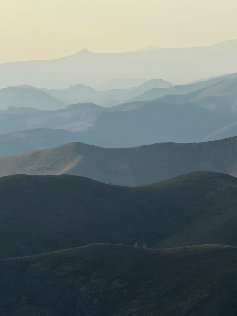 Layered Blue Mountain Ridges in Haze
