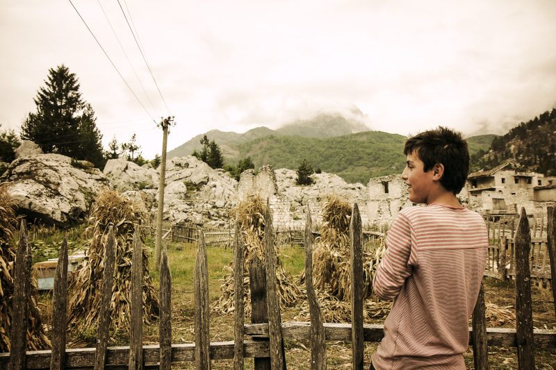 Boy by a Wooden Fence in Valbona