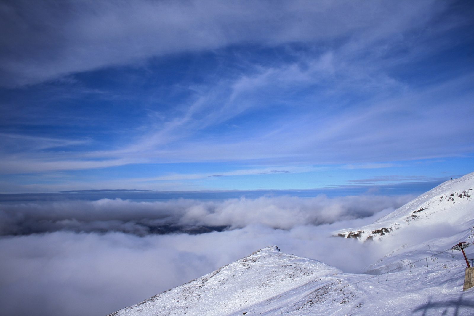 Clouds Rolling Over Snowy Mountains