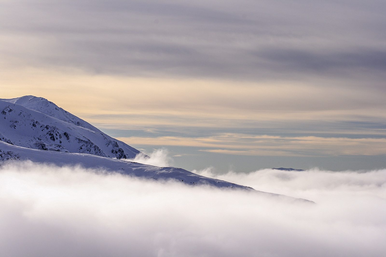 Snowy Ridge Above a Sea of Clouds