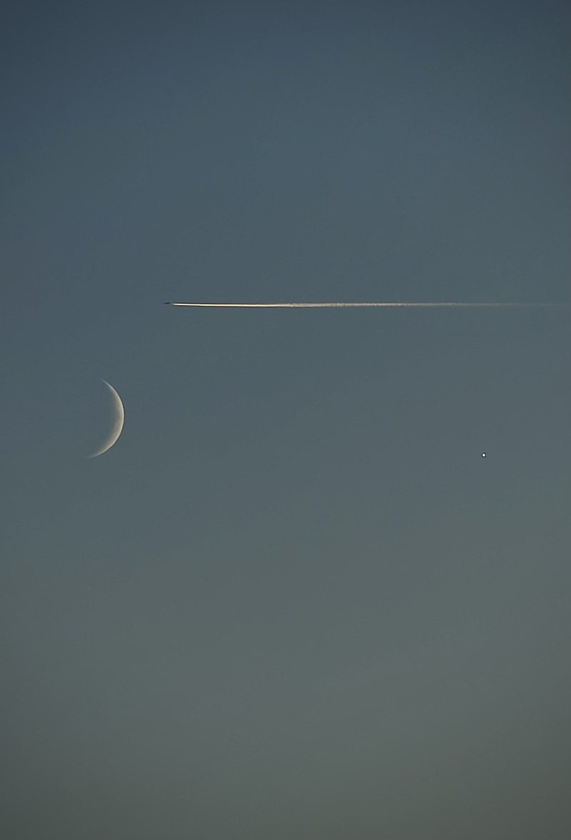 Thin Crescent Moon and a Plane Trail