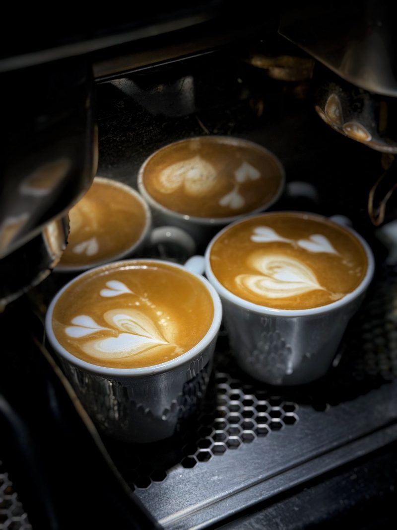 Three Lattes with Heart Art on an Espresso Machine